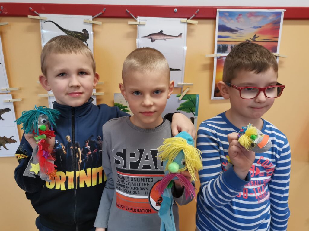Chłopcy z zabawkami wykonanymi z używanych skarpetek i rękawiczek.